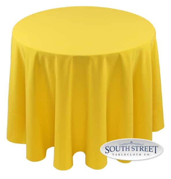 A round table with a yellow cloth